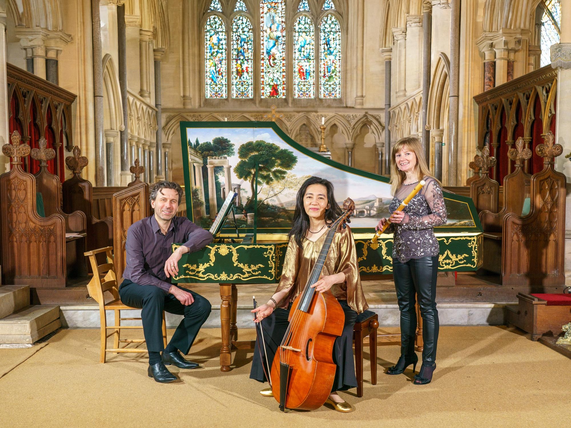 3 members of Passacaglia with instruments in the nave of a large church